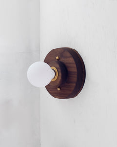 This wood surface mount or flush mount-style light in Black Walnut is designed to be installed on a ceiling or as a wall sconce, alone or in multiples. Inspired by a 1930s fixture, this light is the perfect solution for a home with lower ceilings or an old house remodel that is seeking to be connected to the past. Designed and made in the Hudson Valley. Wood light, contemporary light, kitchen, sconce, ceiling