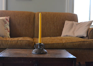 Our pure beeswax tapers are each hand-poured in antique metal candle molds. Imperfections are the result of the age of the molds and the miles they've traveled. Single candle.  Metal candleholder, living room, antique style