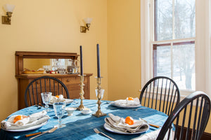 a dining room table with a blue tablecloth 