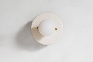 This porcelain surface mount or flush mount-style light is designed to be installed on a ceiling or as a wall sconce, alone or in multiples. Inspired by a 1930s fixture, this light is the perfect solution for a home with lower ceilings or an old house remodel that is seeking to be connected to the past. Designed and made in the Hudson Valley, classic, clean, white, modern, contemporary light, high-end design, luxury design