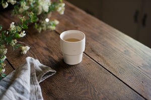 An elegant cup for every beverage at every temperature. This form is inspired by ceramics found in archaeological digs at the Historic 1747 Parsonage in Germantown, New York. Coffee cup, wine cup, porcelain, linen, old house style, white