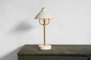 Hand-thrown shade in semi-translucent porcelain glows softly when illuminated, revealing the hand of the maker. Cast porcelain base and brass body. Touch switch. Designed and made in our workshop in the Hudson Valley. Lamp, library, desk, luxury design, porcelain, brass, high-end