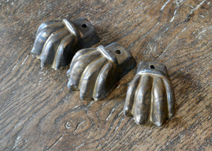 Set of three glazed planter feet with a bronzy brown metallic glaze. Pairs well with earth tone glazed planters, reds, greens, and terra cotta tones. Quittner.