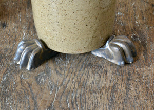 Set of three glazed planter feet with a bronzy brown metallic glaze. Pairs well with earth tone glazed planters, reds, greens, and terra cotta tones. Quittner.