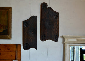 These are antique carved wood panels, sold individually. Possibly previously doors or inset panels. There are ribbons on the back for hanging from a picture hook or nail. Quittner. 