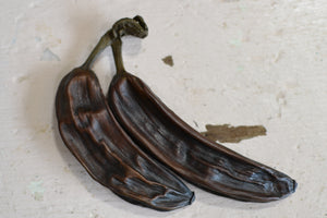 a pair of black scissors sitting on top of a counter 