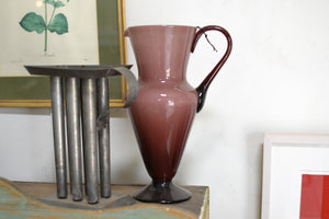 a brown vase sitting on top of a table 