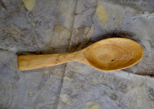 cherry carved spoon. This piece was carved by Mark Power. He uses hardwoods local to the Hudson Valley sourced from fallen trees and trimmings from local orchards. Mark carves while the wood is green, or still fresh, using edge tools. The pieces are finished with tung oil, which is durable and food safe.
