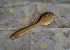 Black Walnut cooking and serving spoon. This piece was carved by Mark Power. He uses hardwoods local to the Hudson Valley sourced from fallen trees and trimmings from local orchards. Mark carves while the wood is green, or still fresh, using edge tools. The pieces are finished with tung oil, which is durable and food safe.