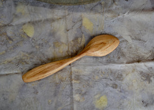 Cherry wood serving spoon. This piece was carved by Mark Power. He uses hardwoods local to the Hudson Valley sourced from fallen trees and trimmings from local orchards. Mark carves while the wood is green, or still fresh, using edge tools. The pieces are finished with tung oil, which is durable and food safe.