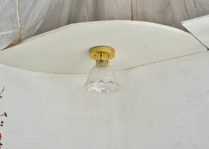 Antique glass Holophane flush mount light fixture with a ruffle rim for the ceiling with brass hardware. Quittner.