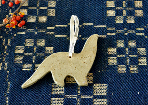 A playful dinosaur ornament for holiday decorations. Made in by Quittner in the Hudson Valley of New York.