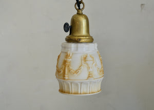 Antique glass pendant with a pressed pattern design and painted detail. Cast brass shade holder and brass hardware. Cloth-covered cord. Ideal for over a kitchen or pantry sink, or in a laundry or powder room. Quittner.