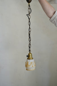 Antique glass pendant with a pressed pattern design and painted detail. Cast brass shade holder and brass hardware. Cloth-covered cord. Ideal for over a kitchen or pantry sink, or in a laundry or powder room. Quittner.