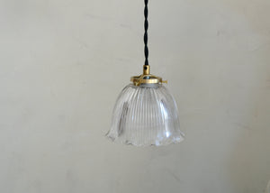 Antique glass Holophane pendant with a bell-shaped form. Cast brass shade holder and brass hardware. Cloth-covered cord. Ideal for over a kitchen or pantry sink, or in a laundry or powder room. Quittner.