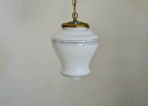 White hanging lamp with gold trim against a plain background