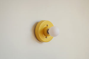 This porcelain surface mount or flush mount-style light is designed to be installed on a ceiling or as a wall sconce, alone or in multiples. Inspired by a 1930s fixture. Designed and made in the Hudson Valley.

The Marigold color is one of a trio of colors released in collaboration with Hudson Valley interior design firm Hendley and Co.