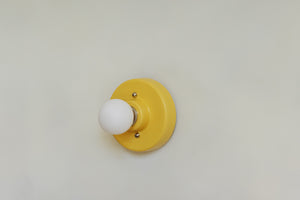This porcelain surface mount or flush mount-style light is designed to be installed on a ceiling or as a wall sconce, alone or in multiples. Inspired by a 1930s fixture. Designed and made in the Hudson Valley.

The Marigold color is one of a trio of colors released in collaboration with Hudson Valley interior design firm Hendley and Co.