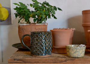 This large 16oz mug was handmade by potter Lara Gillett using slab-building techniques. It features a fish scale motif and a blue glaze, and you will receive the exact mug shown. Quittner. Hudson Valley.