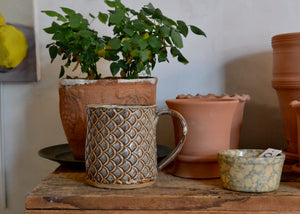 This large 16oz mug was handmade by potter Lara Gillett using slab-building techniques. It features a fish scale motif and a creamy glaze, and you will receive the exact mug shown. Quittner. Hudson Valley.