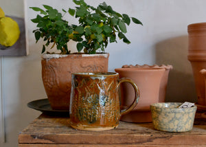 This large 16oz mug was handmade by potter Lara Gillett using slab-building techniques. It features a mountain motif and a speckled glaze. Each mug is handmade, and variations are part of the magic. Quittner. Hudson Valley.