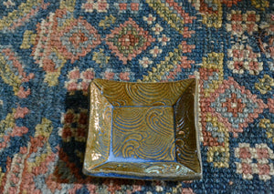 This is a small snack plate for your desk, ring dish for your bedside table, or landing zone for a wet tea bag. Use it for whatever needs a small spot to rest. Stamped wave design with blue glaze. Quittner. Lara Gillett. Hudson Valley Made.