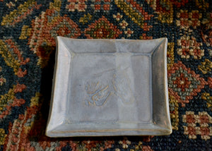 This is a snack plate for your desk, jewelry dish for your bedside table, or landing zone for your favorite mug. Use it for whatever needs a spot to rest. Stamped with a horse in profile and finished with a soft blue glaze. Lara Gillett. Quittner. Hudson Valley.