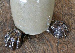 Set of three glazed planter feet with a foundational brown color topped off with an oil slick-like metallic. Pairs well with earth tone glazed planters, reds, and greens. Quittner.