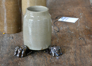 Set of three glazed planter feet with a foundational brown color topped off with an oil slick-like metallic. Pairs well with earth tone glazed planters, reds, and greens. Quittner.