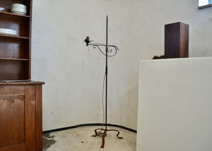 This antique metal floor lamp has an adjustable 'bridge' style arm and single bulb that can be fitted with a shade. For pick-up or local delivery only. Shipping by special arrangement. Quittner.