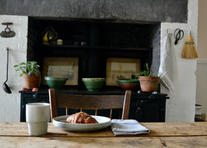 A dinner plate with an elegant lip and a scalloped edge, inspired by ceramics found in archaeological digs at the Historic 1747 Parsonage in Germantown, New York. Quittner.