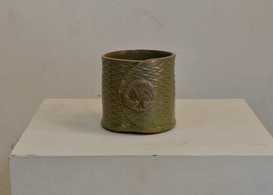 A small planter pot handmade by potter Lara Gillett using slab-building techniques. Glazed with drainage holes and small ball feet. You will receive the pot shown. Quittner.