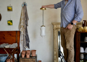 Pendant light featuring a vintage blown opaque glass form and brass details, offering a warm glow. Rewired. Please look carefully at images to confirm condition. Quittner.