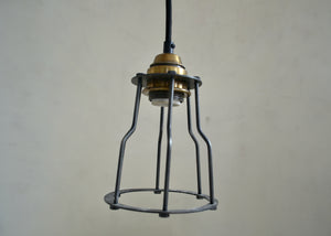 Vintage-style pendant light with brass fitting on a plain background
