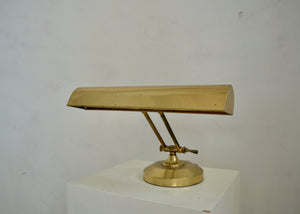 Vintage metal desk lamp with adjustable neck and shade. Newly rewired with a cloth-covered cord. Quittner