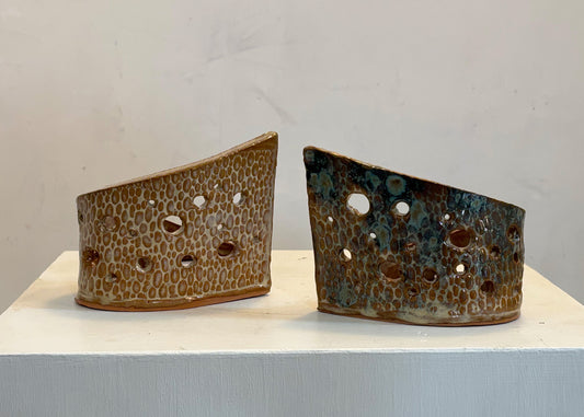 This tea light luminary was handmade by potter Lara Gillett using slab-building techniques. It features a spot motif and a choice of glaze.