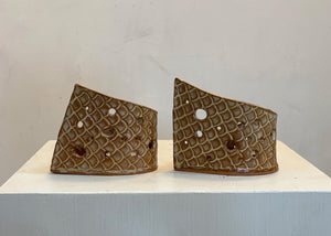 This tea light luminary was handmade by potter Lara Gillett using slab-building techniques. It features a scale motif and a choice of glaze.