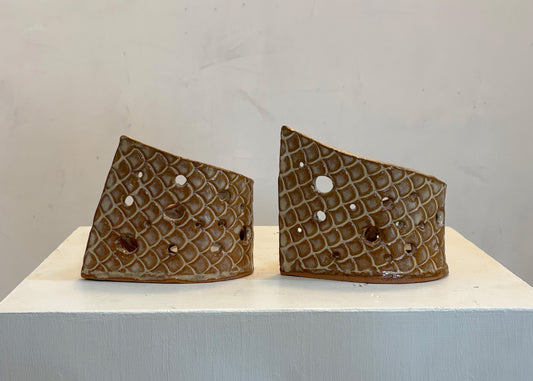 This tea light luminary was handmade by potter Lara Gillett using slab-building techniques. It features a scale motif and a choice of glaze.