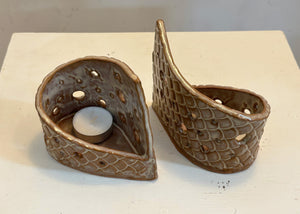This tea light luminary was handmade by potter Lara Gillett using slab-building techniques. It features a scale motif and a choice of glaze.