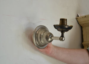 Antique nickel and brass-toned sconce with wear and patina. Fully rewired. Please look carefully at images to confirm condition. Quittner.