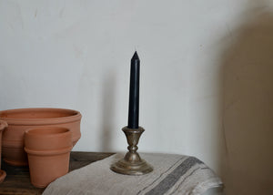 Our pure beeswax tapers are each hand-poured in antique metal candle molds. Imperfections are the result of the age of the molds and the miles they've traveled. Single candle in Black. Quittner. 