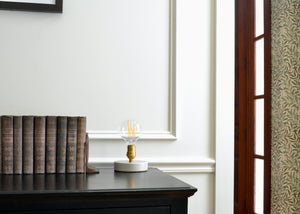 Designed to be a clean and elegant addition to a nightstand or reading nook, the Simple Lamp is just that — simple. A hand cast porcelain base anchors a brass socket with a natural living finish that will patina over time. Fitted with a touch sensor, you turn the Simple Lamp on or off by simply taping the brass socket with a finger. Quittner.