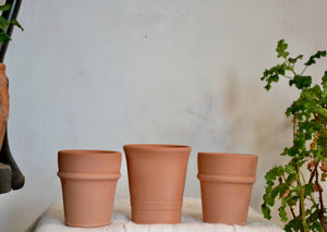 Small planter pots hand-thrown in terra cotta with decorative banding. Each pot has a drainage hole, and is ideal for a countertop herb, seasonal flower like a pansy or marigold, or a single bulb. Firehouse Pottery Co. Athens, NY Quittner Hudson Valley