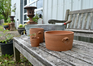 Our red stoneware #2 pots are part of our collection durable traditional stoneware for the garden made by hand in our studio in the Hudson Valley of New York. Inspired by traditional English planting pots and American stoneware crockery, these planter pots are designed to last through the seasons as treasured utilitarian objects that truly work. Each pot includes a drainage hole, and should be used with a saucer if indoors. Quittner.