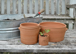Our red stoneware #2 pots are part of our collection durable traditional stoneware for the garden made by hand in our studio in the Hudson Valley of New York. Inspired by traditional English planting pots and American stoneware crockery, these planter pots are designed to last through the seasons as treasured utilitarian objects that truly work. Each pot includes a drainage hole, and should be used with a saucer if indoors. Quittner.
