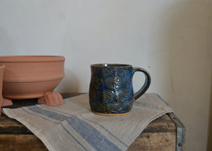 This large 16oz mug was handmade by potter Lara Gillett using slab-building techniques. It features a wave motif. Quittner.