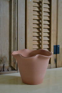 Hand-thrown in terra cotta pot with decorative scallop that is ideal for a countertop woody herb like rosemary, sage, or thyme, a seasonal flower like a pansy or marigold, or a trio of bulbs. This pot does not have a drainage hole. Firehouse Pottery Co. Quittner.