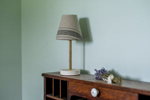 Our surface lamp is the perfect small lamp for your counter, dresser, desk, or bedside table. Brass and porcelain with linen shade, classic, simple, clean design, old house style, cottage, English, desk, bedroom
