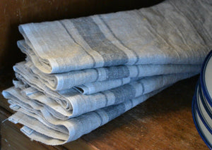 a stack of towels on a wooden table 