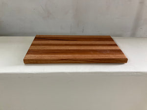 a wooden bench sitting in the middle of a room 